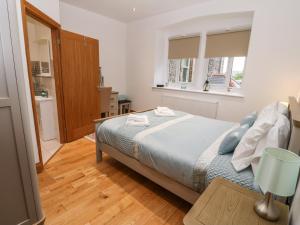 a bedroom with a bed and a table in it at On the Straits in Menai Bridge