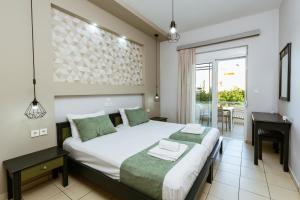 1 dormitorio con cama, mesa y ventana en Gelina Apartments, en Plataniás