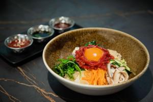 a bowl of food sitting on a table at Kimpton Aysla Mallorca by IHG in Santa Ponsa