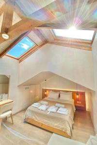 a bedroom with a large bed with a skylight at Panellinion Luxury Rooms in Kalamata