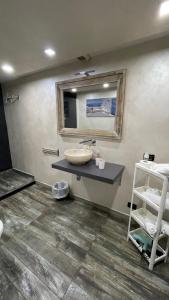 a bathroom with a sink and a mirror at IDEAL LOFT IN CENTRO TORINO in Turin