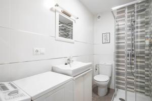 a white bathroom with a sink and a toilet at Ponferrada Castillo in Ponferrada