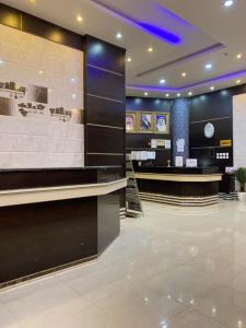 a hotel lobby with a reception desk and a counter at Qasr Aldabab Housing Units in Abha