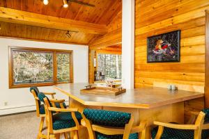 a dining room with a large wooden table and chairs at Sand Lake View House in Anchorage