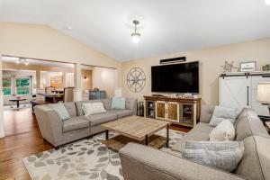 a living room with couches and a flat screen tv at Gourmet Cook's Retreat in Cannon Beach