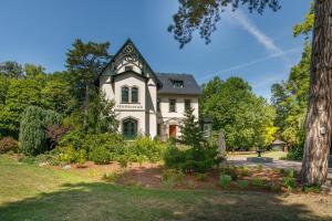 ein weißes Haus mit einem Gameradach in der Unterkunft Luxus Hotel Design Villa Ottilienruh Ilsenburg im Harz in Ilsenburg