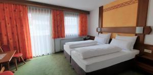 Postel nebo postele na pokoji v ubytování Hotel Garni Belvedere