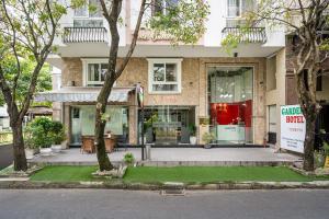 a house with a sign in front of it at La Palma - Garden Saigon Hotel Phu My Hung in Ho Chi Minh City