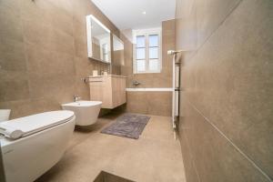 a bathroom with a toilet and a sink at Luxury 3 bedroom apartment - old town of Sion in Sion