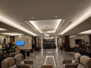 a lobby of a hotel with couches and a bar at Brzeen Hotel Riyadh in Riyadh