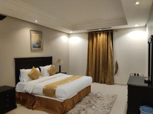מיטה או מיטות בחדר ב-Brzeen Hotel Riyadh