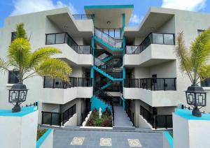 a building with a staircase in front of it at Hillsboro Suites & Residences Condo Hotel, St Kitts in Basseterre