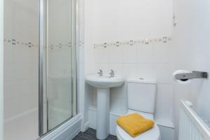 a bathroom with a sink and a toilet and a shower at Great Park Townhouse in Preston