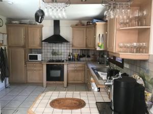 a kitchen with wooden cabinets and a stove top oven at Chalet Peloton in La Chapelle-dʼAbondance