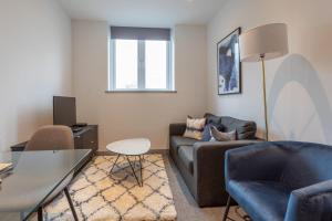 a living room with a couch and a table at Fantastic 1 Bedroom Apartment Leeds in Leeds