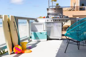 a grill on the deck of a boat with surfboards at Belmont by AvantStay 3BR Home on Mission Beach Ocean Views in San Diego