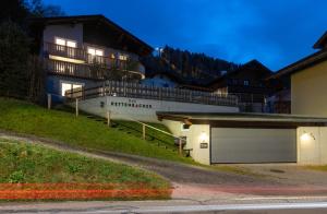 a building on a hill with a garage at Appartements DAS RETTENBACHER in Schladming