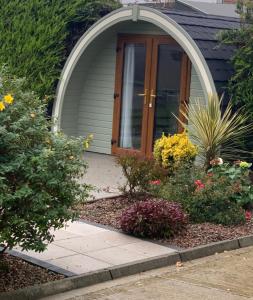 a front door of a house with a bunch of flowers at The Burrow - Sleeps 4 in Burnfoot