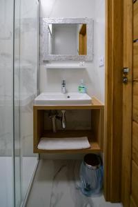 a bathroom with a sink and a glass shower at Hotel Duet in Chełm