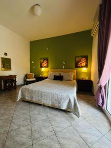 a bedroom with a bed and a green wall at Villa Domenico in Vryses