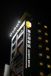 JIASHITE HOTEL في تاويوان: مبنى عليه علامة في الليل