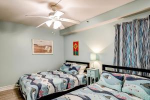 a bedroom with two beds and a ceiling fan at x Sea Marsh II 503 in Myrtle Beach