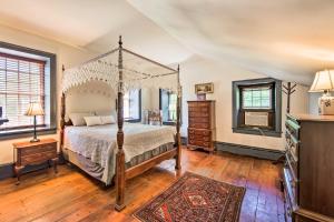 a bedroom with a canopy bed and a television at Beautiful Historic House In Amish Country in Ephrata