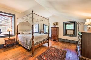 a bedroom with a canopy bed and a television at Beautiful Historic House In Amish Country in Ephrata