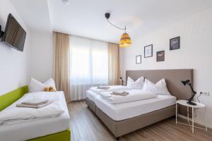 Łóżko lub łóżka w pokoju w obiekcie Appartements DAS RETTENBACHER