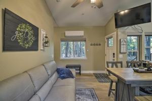 a living room with a couch and a table at Secluded Butte Meadows Cabin with Deck and Grill! 