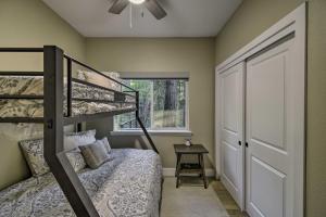 a bedroom with a bunk bed and a window at Secluded Butte Meadows Cabin with Deck and Grill! 