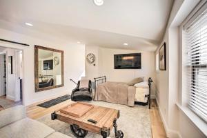 a living room with a bed and a table at Adorable Castle Rock Cottage Walk to Town! in Castle Rock