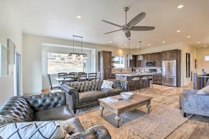 a living room with leather couches and a kitchen at Scenic Eden Gem with Hot Tub about 6 Mi to Ski Area in Eden