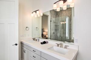 a bathroom with two sinks and a large mirror at Scenic Eden Gem with Hot Tub about 6 Mi to Ski Area in Eden +33 photos