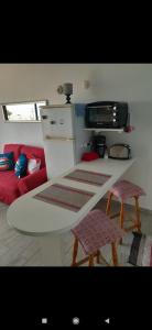 a kitchen with a white table and two chairs at Dunes to explore and relax right by the desert wifi in Corralejo