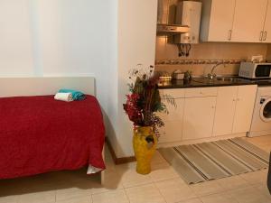 a kitchen with a vase with flowers in it at Beautiful 1-Bed Apartment in Aldeia de Paio Pires in Aldeia de Paio Pires