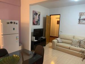 a living room with a couch and a table at Beautiful 1-Bed Apartment in Aldeia de Paio Pires in Aldeia de Paio Pires