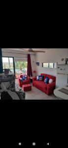 a living room with two red couches at Dunes to explore and relax right by the desert wifi in Corralejo