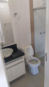 a bathroom with a toilet and a sink and a shower at APARTAMENTO ACQUA DI FIRENZE CAPAO in Capão da Canoa