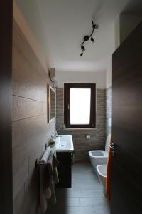 a bathroom with two toilets and a sink and a window at PETITE MAISON in Lanciano
