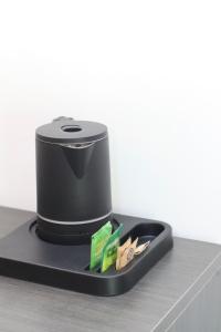 a black hat on a tray on a table at CasAlbergo - Superior Lake Apartments in Castelletto sopra Ticino