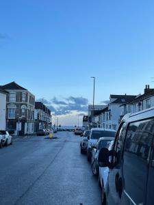 a street with cars parked on the side of the road at Modern Studio with Free Parking near sea-station-shops in Portslade