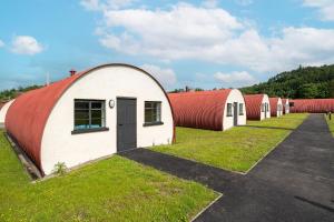 a row of domed buildings with red roofs at Cultybraggan Hut 35 in Comrie