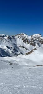 une chaîne de montagnes enneigée avec des montagnes en arrière-plan dans l'établissement L’appart chic gapençais, à Gap