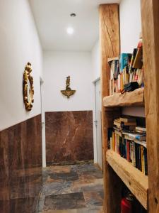 a hallway with a book shelf with books at XuBa ApartmentRooms Messe Wien Prater in Vienna