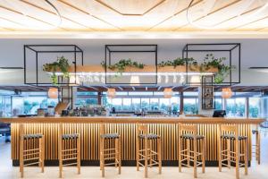 a rendering of a restaurant with a bar and stools at Malena Hotel & Suites - Adults Only by Omilos Hotels in Amoudara Herakliou