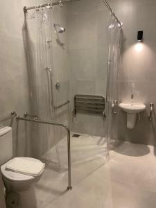 a bathroom with a shower and a toilet and a sink at Morada Inn Hotel in Franca