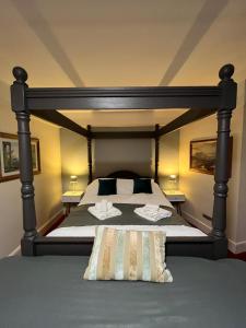 a bedroom with a large bed with two pillows at Castle Inn in Hythe