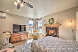 a bedroom with a bed and a tv and a fireplace at Williams Studio on Famous Route 66 with Fireplace! in Williams
