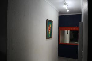 a hallway with a mirror and a painting on a wall at Sable Holiday Home in Hazyview